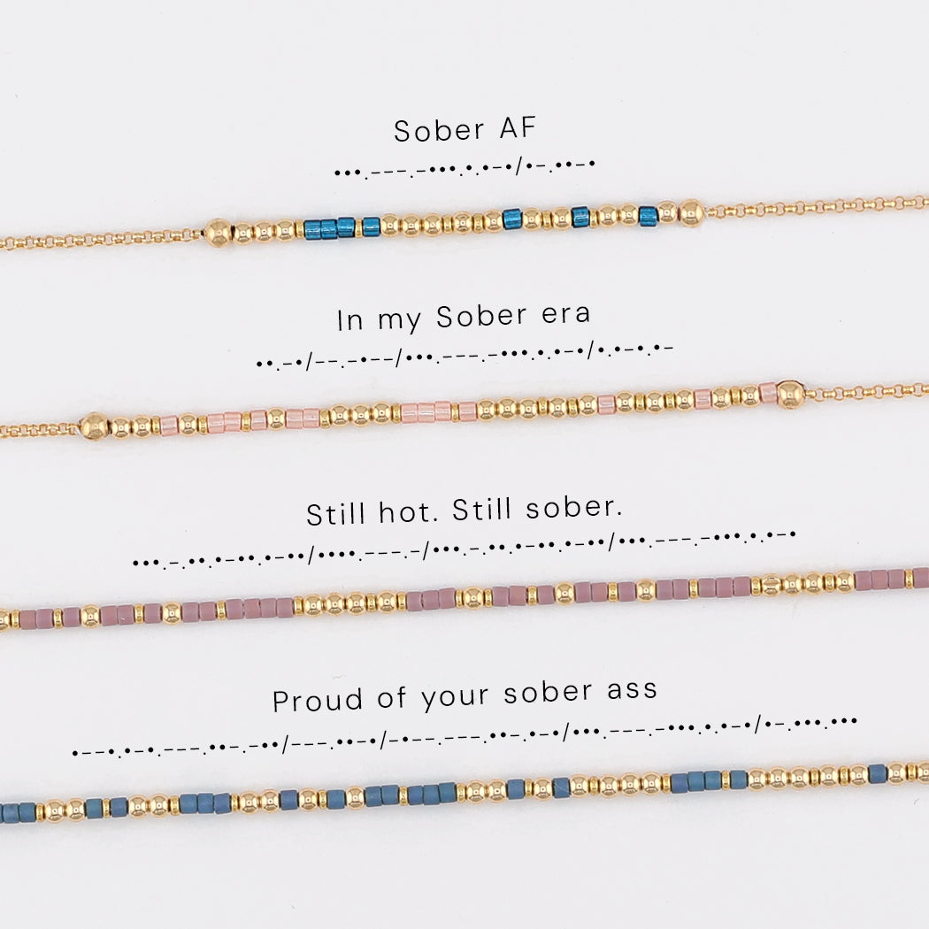 Four sobriety Morse code bracelets shown with their phrases