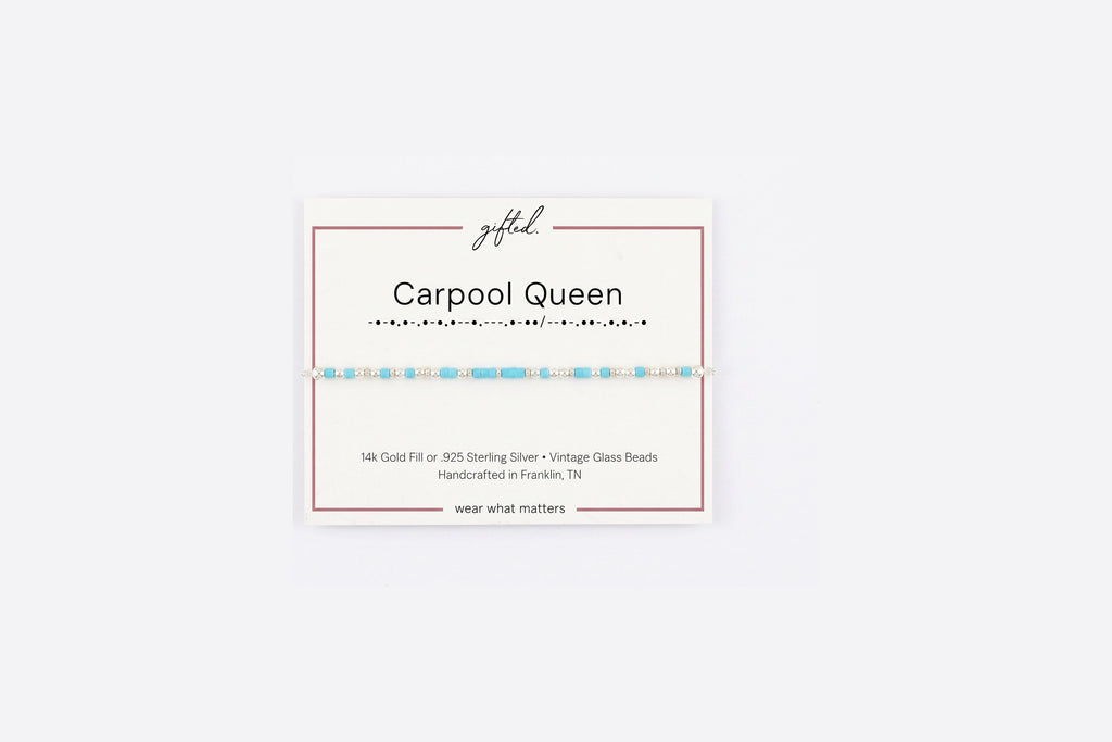 Carpool queen spelled in Morse code in glass and metal beads on a gifted. card.