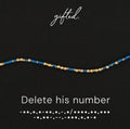 Delete his number spelled in Morse code in glass and metal beads, shown on black