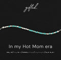 In my hot mom era spelled in Morse code in glass and metal beads, shown on black