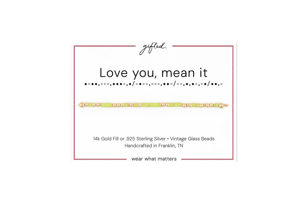 Love you, mean it spelled in Morse code in glass and metal beads on a gifted. card.