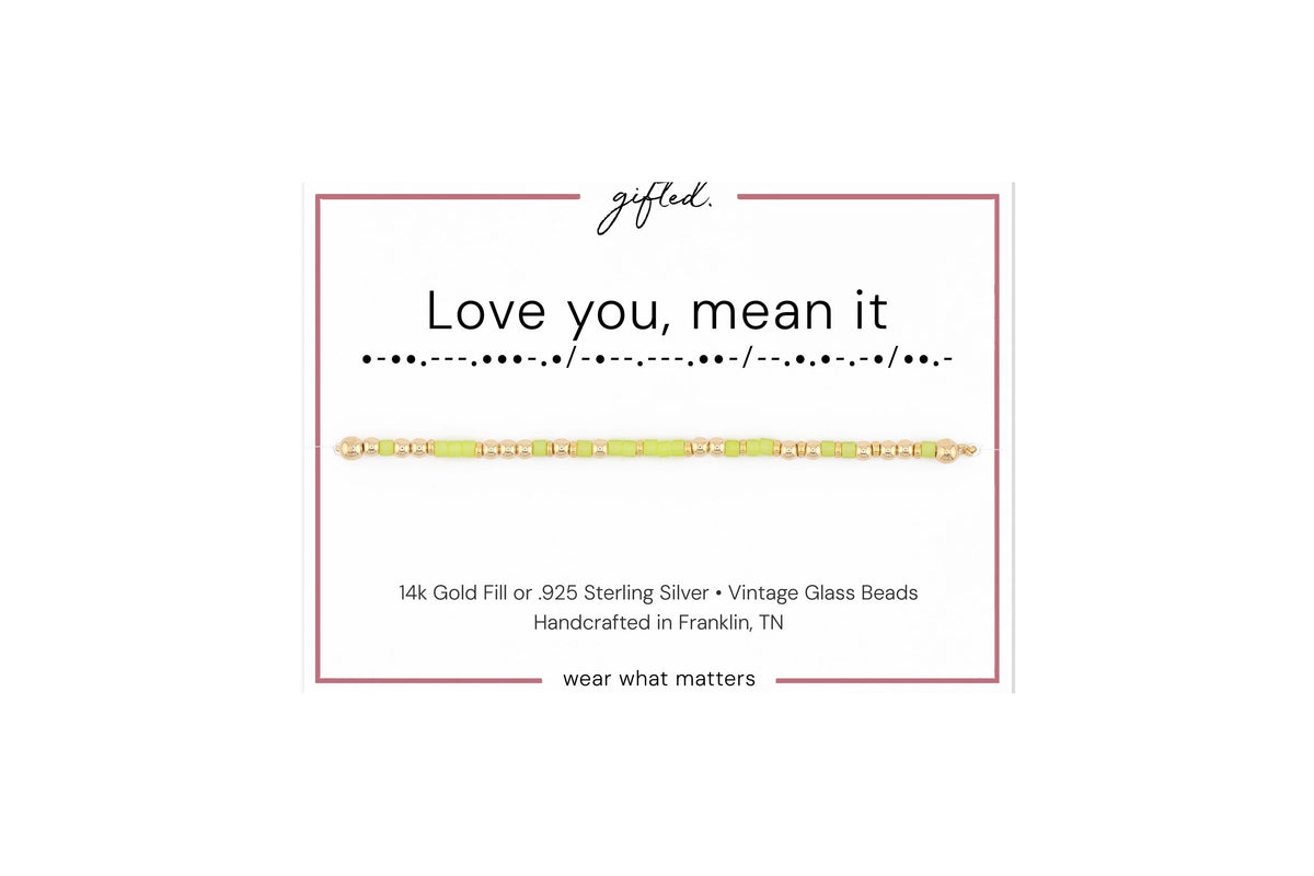 Love you, mean it spelled in Morse code in glass and metal beads on a gifted. card.