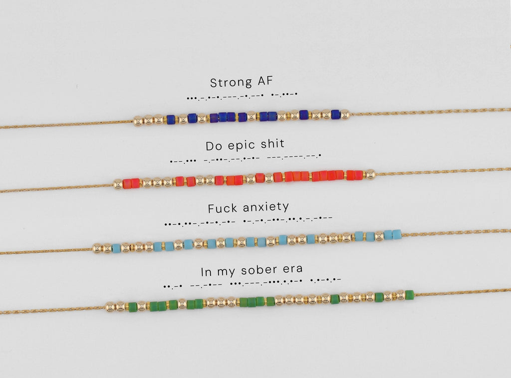 Four Morse code necklaces shown with their phrases decoded