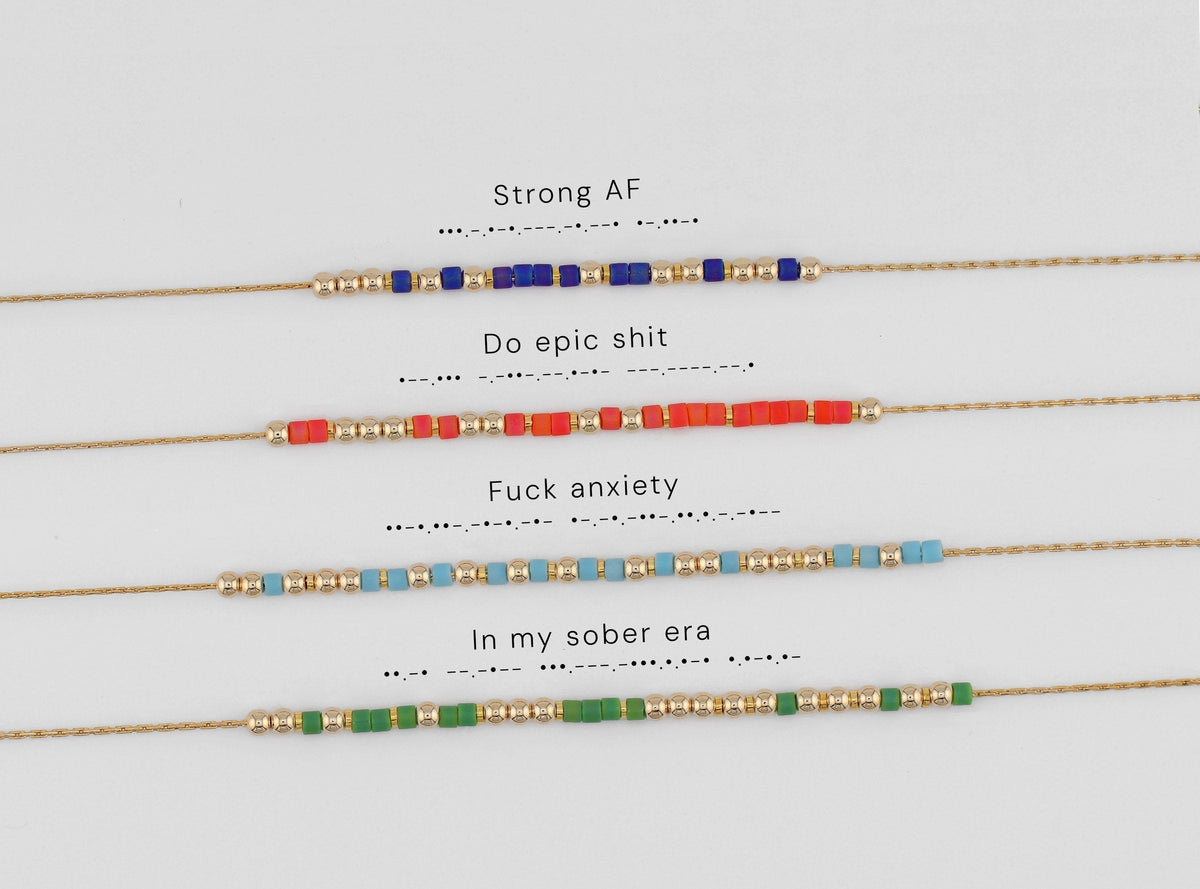 Four Morse code necklaces shown with their phrases decoded