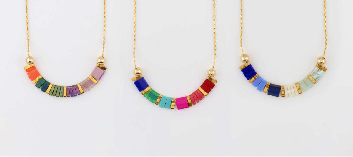 Three gifted. necklaces on fine gold chain, strung with coloured glass beads in coral, teal, cobalt and rose.