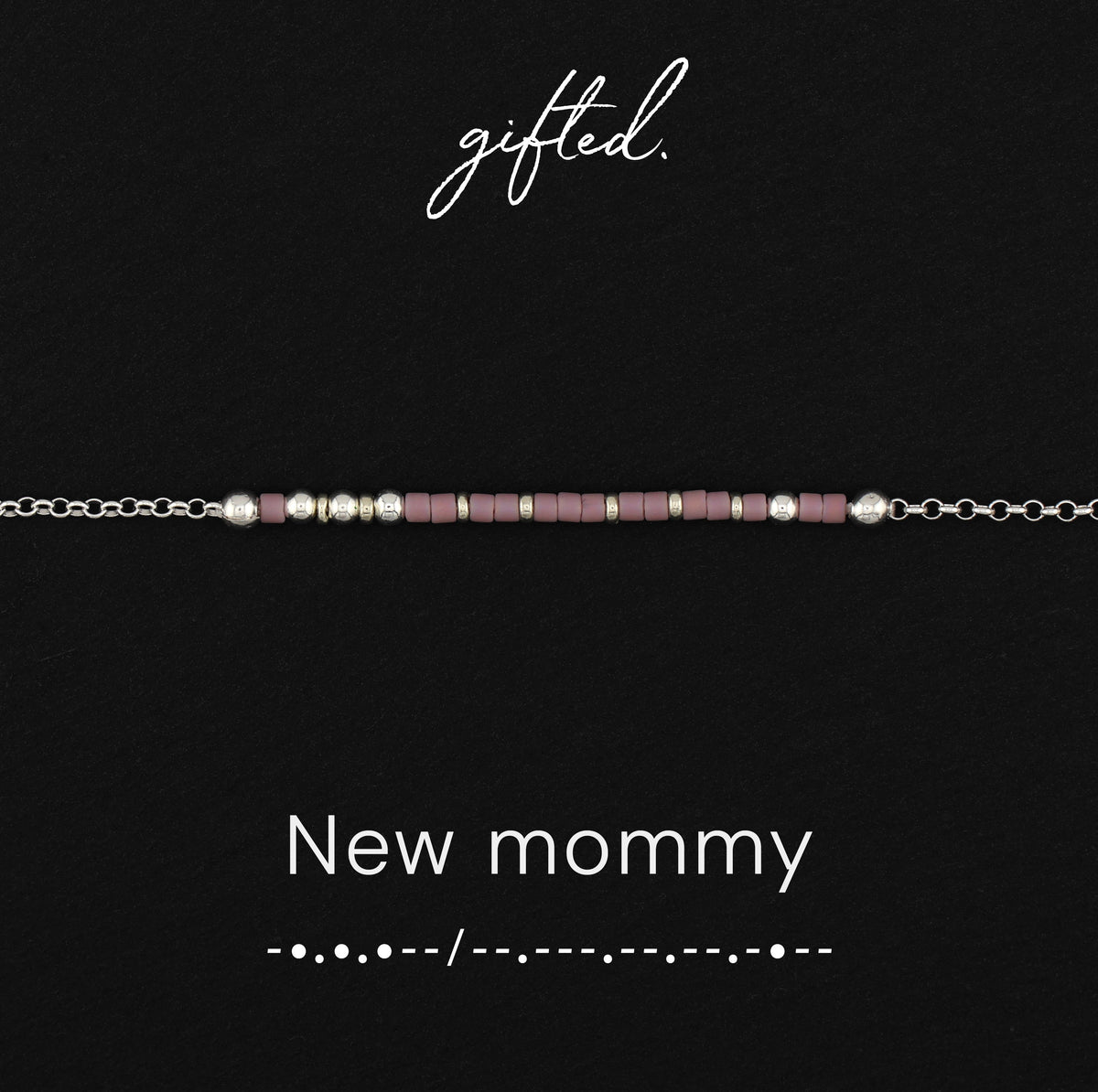 New mommy spelled in Morse code in glass and metal beads, shown on black