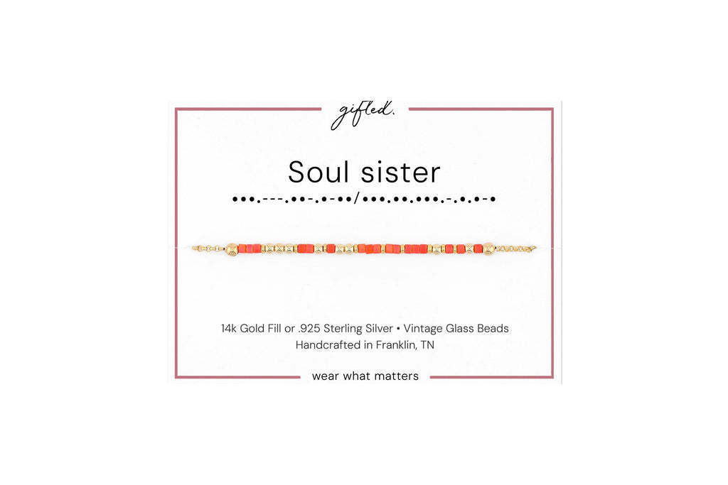 Soul sister spelled in Morse code in glass and metal beads on a gifted. card.