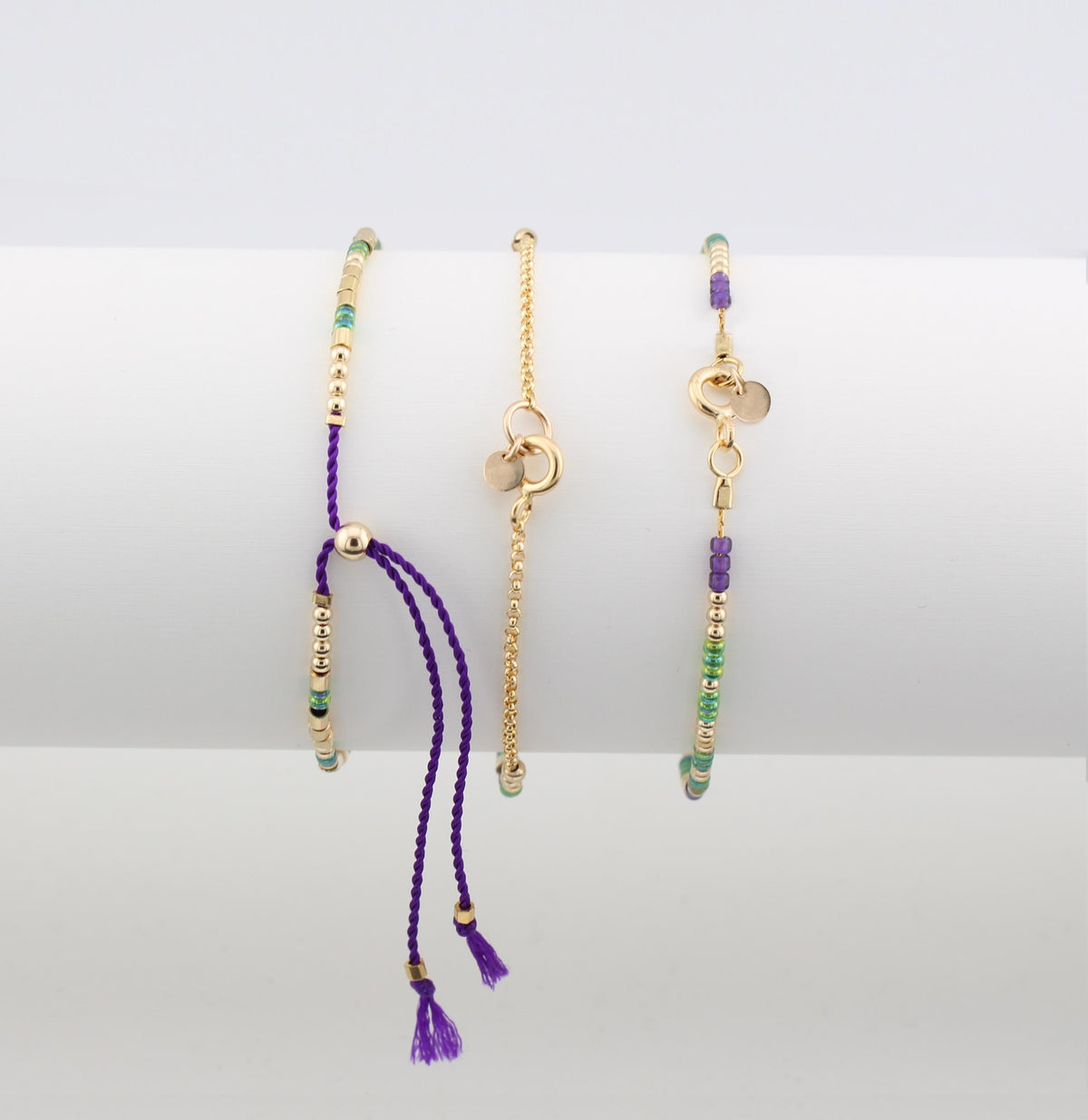 Three morse code bracelets side by side showing silk cord and chain closures
