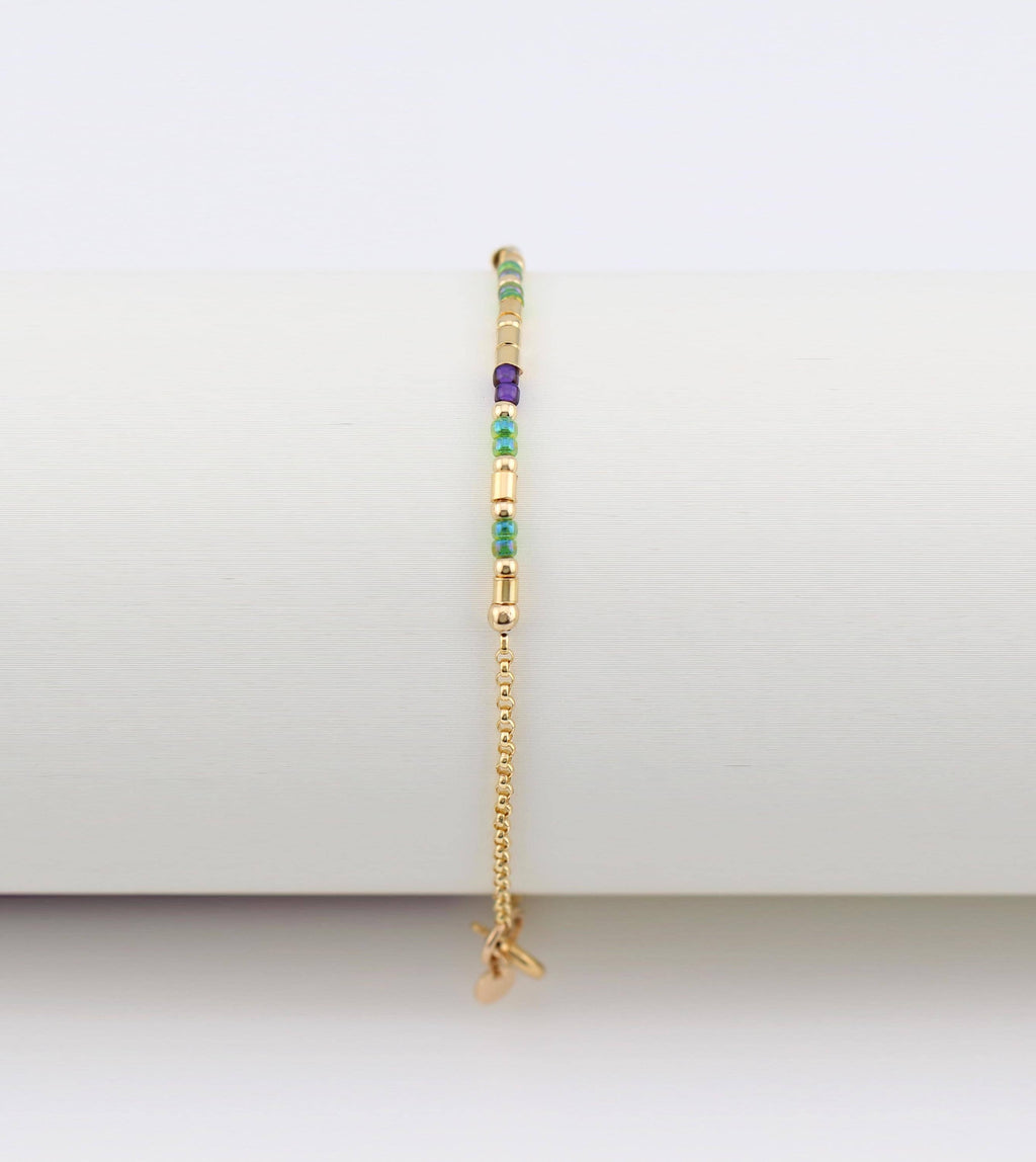 14k gold fill morse code bracelet hanging vertically, showing the gifted. tag charm at the clasp