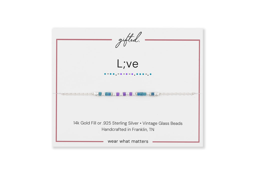 L;ve spelled in Morse code on a beaded bracelet, shown on its printed gift card