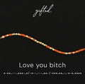 Love you bitch spelled in Morse code in beads on a gifted. card
