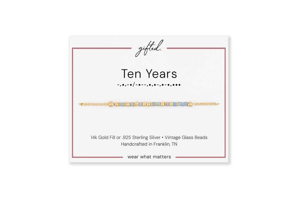 Ten Years spelled in Morse code on a beaded bracelet, shown on its printed gift card