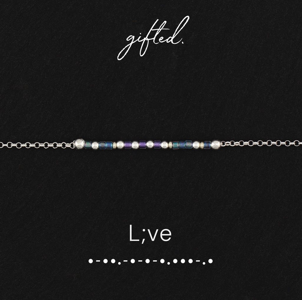 L;ve spelled in Morse code in glass and metal beads, shown on black