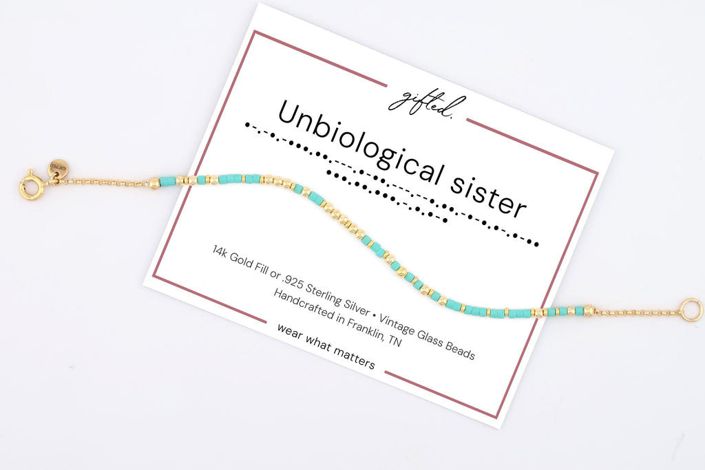 Unbiological sister spelled in Morse code in beads on a gifted. card