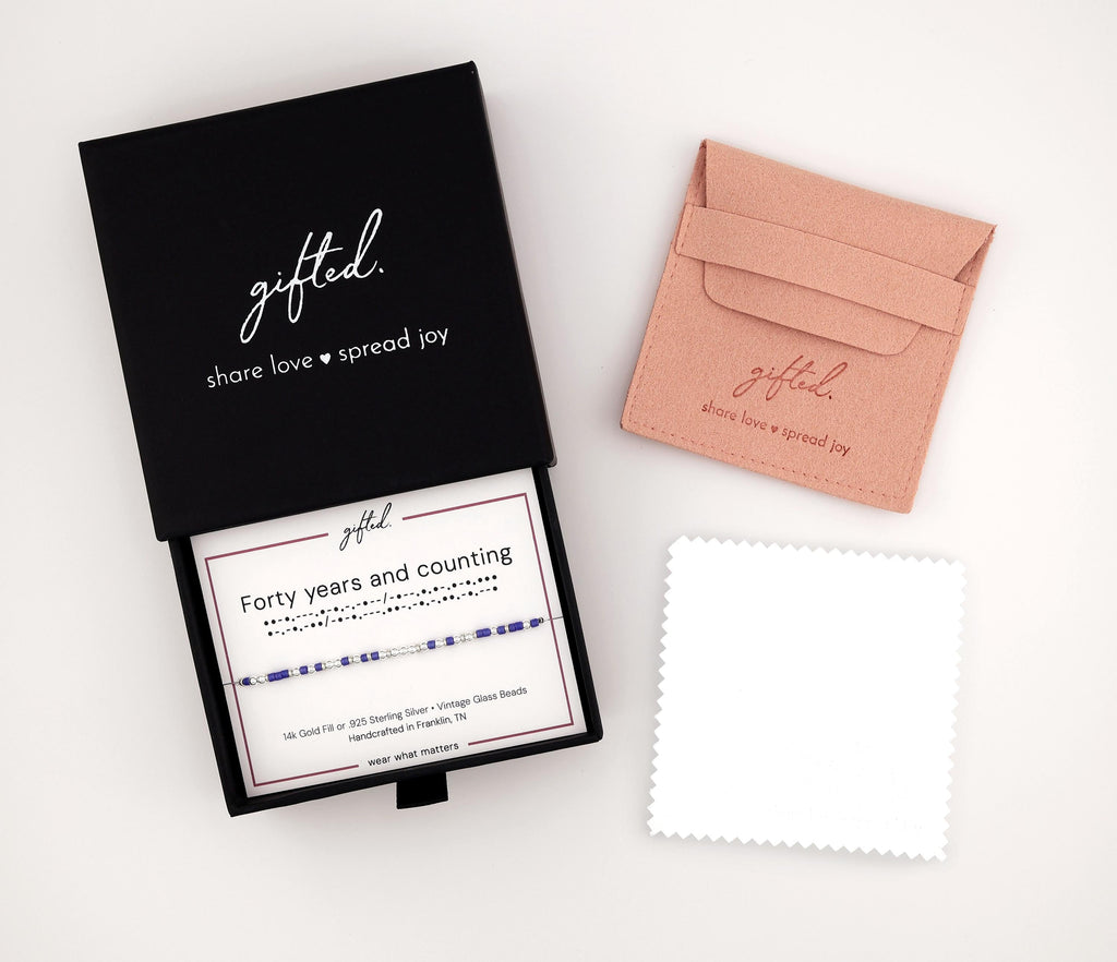The gifted. gift box, pouch and polishing cloth, with a bracelet on its printed card