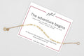 The Adventure Begins spelled in Morse code on a beaded bracelet, shown on its printed gift card