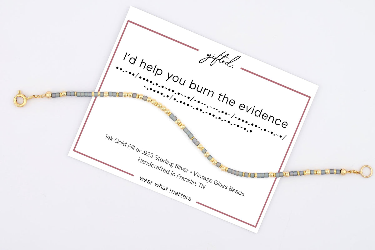 I'd Help You Burn the Evidence spelled in Morse code on a beaded bracelet, shown on its printed gift card