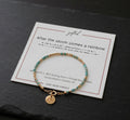 Morse code bracelet in 14k Gold Fill with turquoise beads and a rainbow charm, on the After the storm comes a rainbow card